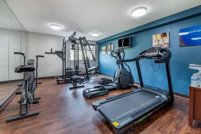 a gym with several treadmills and exercise bikes at Comfort Inn & Suites Napoleon in Napoleon