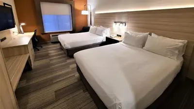a hotel room with two beds and a desk and a television at Holiday Inn Express Lordstown-Newton Falls/Warren by IHG in Newton Falls