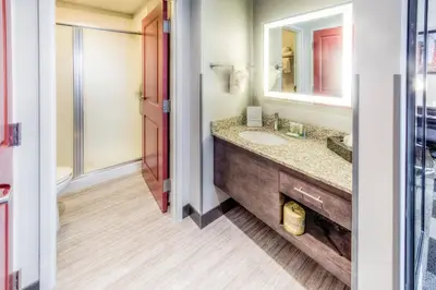 a bathroom with a sink and a mirror at Staybridge Suites - University Area OSU by IHG in Columbus