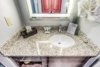 a bathroom counter with a sink and a mirror at Staybridge Suites - University Area OSU by IHG in Columbus