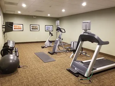 a gym with several exercise bikes and a treadmill at Staybridge Suites Toledo - Rossford - Perrysburg by IHG in Rossford