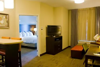 a hotel room with a bed and a television at Staybridge Suites Toledo - Rossford - Perrysburg by IHG in Rossford