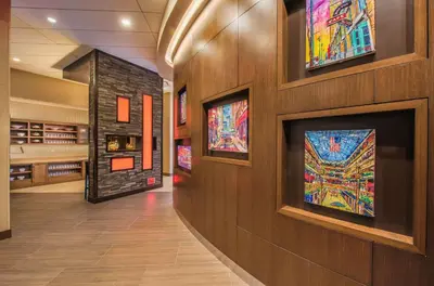 a hallway with paintings on the walls of a building at Hyatt Place Cleveland/Westlake/Crocker Park in Westlake