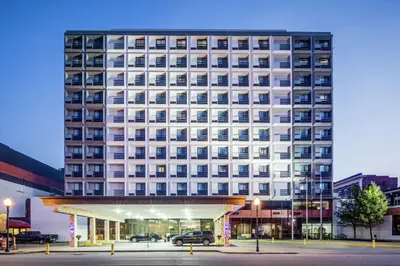 a large white building with a parking lot in front of it at DoubleTree by Hilton Huntington, WV in Huntington