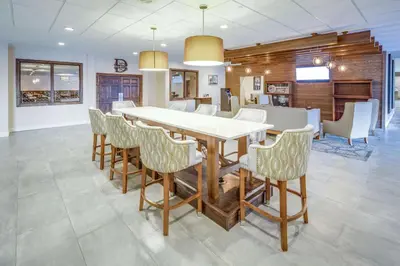 a dining room with a table and chairs at DoubleTree by Hilton Huntington, WV in Huntington