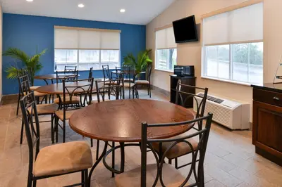 a restaurant with tables and chairs in a room at Americas Best Value Inn & Suites St Clairsville Wheeling in Saint Clairsville
