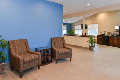 a waiting room with two chairs and a blue wall at Americas Best Value Inn & Suites St Clairsville Wheeling in Saint Clairsville