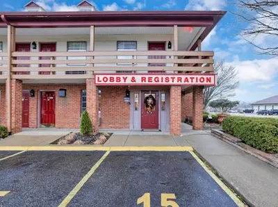 a building with a sign that reads lobby and registration at Red Roof Inn Uhrichsville in Uhrichsville