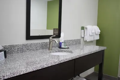 a bathroom with a sink and a mirror at Sleep Inn Ellenboro Hwy 50 in Ellenboro