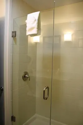 a shower stall with a glass door with a towel at Sleep Inn Ellenboro Hwy 50 in Ellenboro
