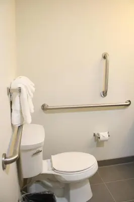 a bathroom with a white toilet and towel racks at Sleep Inn Ellenboro Hwy 50 in Ellenboro