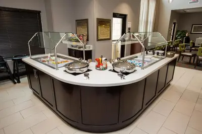 a bathroom counter with three sinks in a room at Staybridge Suites Miamisburg by IHG in Miamisburg