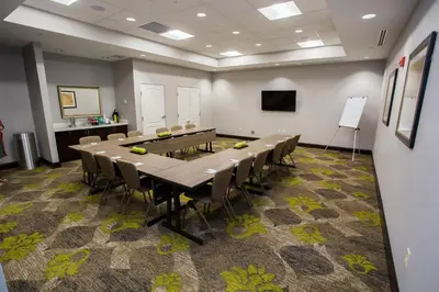 a conference room with a long table and chairs at Staybridge Suites Miamisburg by IHG in Miamisburg