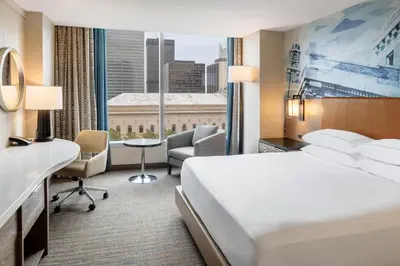 a hotel room with a bed and a large window at Hilton Cleveland Downtown in Cleveland