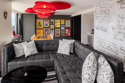 a living room with a couch and a chandelier at Hilton Cleveland Downtown in Cleveland