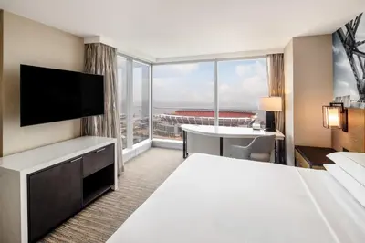 a hotel room with a bed and a large window at Hilton Cleveland Downtown in Cleveland