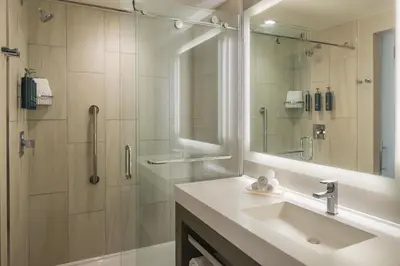 a bathroom with a sink and a shower with a mirror at Hilton Cleveland Downtown in Cleveland