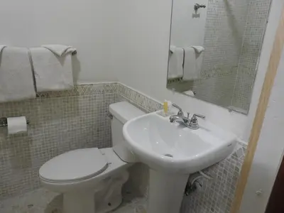a bathroom with a toilet and a sink at Liberty Motel in Liberty