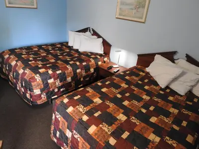 a hotel room with two beds in a room at Liberty Motel in Liberty