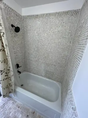 a white bath tub in a tiled bathroom at Liberty Motel in Liberty