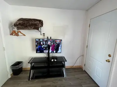 a living room with a tv on a wall at Liberty Motel in Liberty