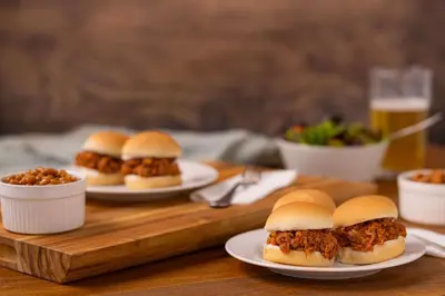 a group of sandwiches on plates on a wooden table at Drury Plaza Hotel Cleveland Downtown in Cleveland