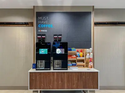 a coffee shop with a sign that says must have coffee at Holiday Inn Express & Suites Toledo West by IHG in Toledo