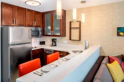 a kitchen with a counter with chairs and a refrigerator at Residence Inn by Marriott Wheeling/St. Clairsville in Saint Clairsville