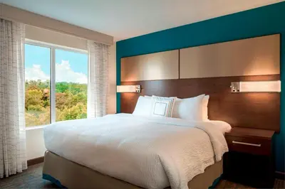 a bedroom with a large bed with a large window at Residence Inn by Marriott Wheeling/St. Clairsville in Saint Clairsville
