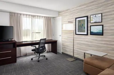 a hotel room with a desk and a chair at Residence Inn by Marriott Wheeling/St. Clairsville in Saint Clairsville