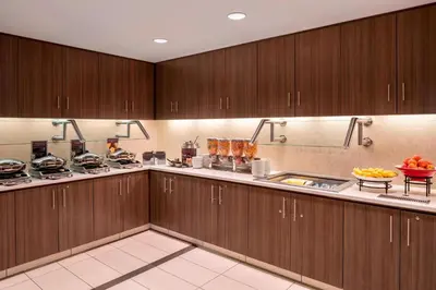 a large kitchen with wooden cabinets and fruits on the counter at Residence Inn by Marriott Wheeling/St. Clairsville in Saint Clairsville