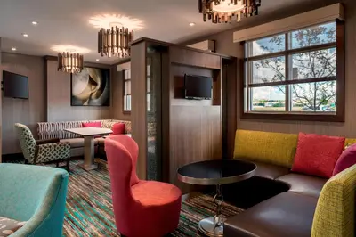 a hotel room with a couch and chairs and a table at Residence Inn by Marriott Wheeling/St. Clairsville in Saint Clairsville