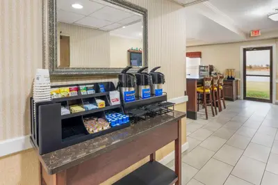 a restaurant lobby with a counter with food at Best Western Celina in Celina