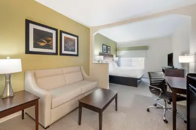 a hotel room with a couch and a bed at Best Western Celina in Celina