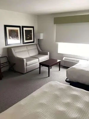 a hotel room with a couch and a bed at Best Western Celina in Celina