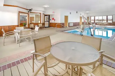 a hotel room with a pool and a table and chairs at Best Western Celina in Celina