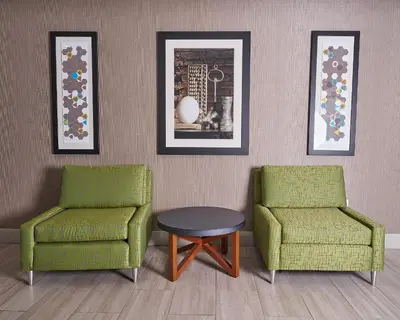 two chairs and a table in a room at Holiday Inn Express Charleston-Civic Center by IHG in Charleston