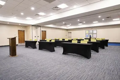 a conference room with tables and chairs in it at Holiday Inn Express Charleston-Civic Center by IHG in Charleston