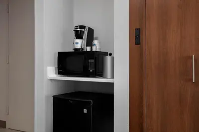 a microwave sitting on a shelf in a room at Holiday Inn Express Charleston-Civic Center by IHG in Charleston