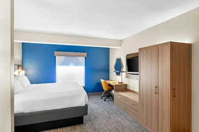 a hotel room with a bed and a desk at Holiday Inn Express Hotel & Suites Charleston-Southridge by IHG in Charleston