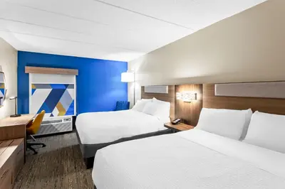 a hotel room with two beds and a desk at Holiday Inn Express Hotel & Suites Charleston-Southridge by IHG in Charleston