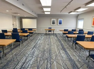 a classroom with desks and chairs in a room at Holiday Inn Express Hotel & Suites Port Clinton-Catawba Island by IHG in Port Clinton