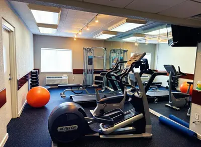 a gym with treadmills and ellipticals in a room at Holiday Inn Express Hotel & Suites Port Clinton-Catawba Island by IHG in Port Clinton