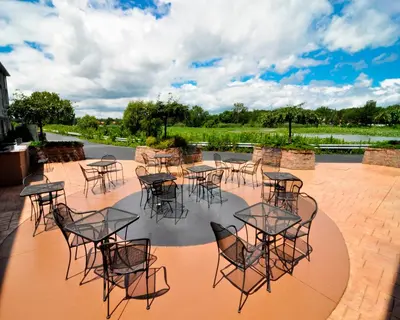 a group of tables and chairs on a patio at Holiday Inn Express Hotel & Suites Port Clinton-Catawba Island by IHG in Port Clinton