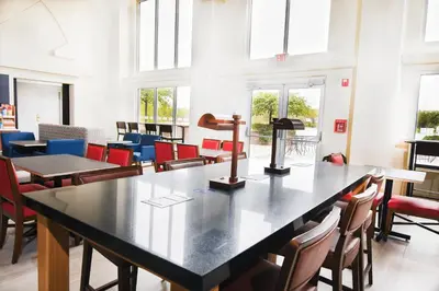 a room with a table and chairs and windows at Holiday Inn Express Hotel & Suites Port Clinton-Catawba Island by IHG in Port Clinton