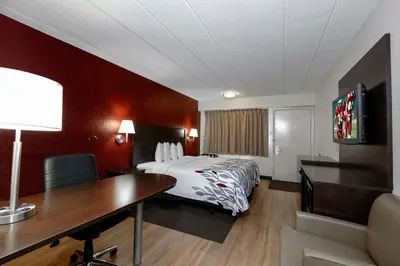 a hotel room with a bed and a desk at Red Roof Inn Cleveland - Medina in Medina