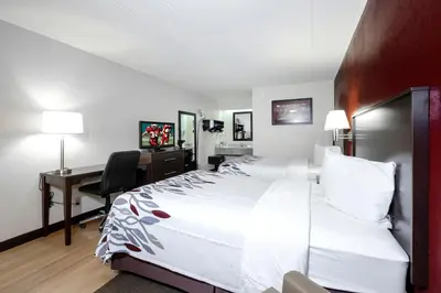 a hotel room with a large bed and a desk at Red Roof Inn Cleveland - Medina in Medina