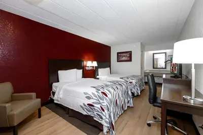 a hotel room with two beds and a desk at Red Roof Inn Cleveland - Medina in Medina