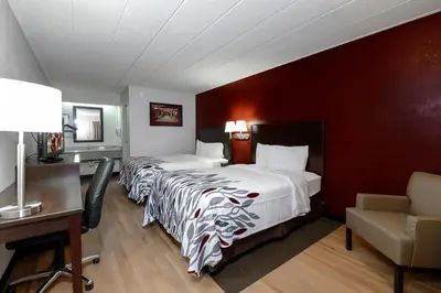 a hotel room with two beds and a desk at Red Roof Inn Cleveland - Medina in Medina