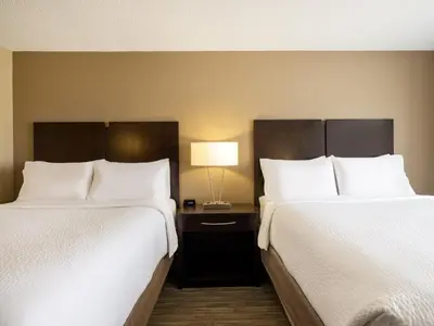 two beds sitting next to each other in a hotel room at Holiday Inn Express Gas City by IHG in Gas City